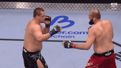 Two Men Fighting In UFC Ring One Wearing Venom Shorts GIF