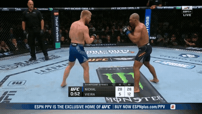 Two Men Fighting In UFC Ring With Monster Can GIF