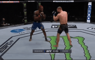 Two Men Fighting In UFC Ring With Monster GIF