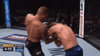 Two Men Fighting In UFC Ring With Motel6 Banner GIF