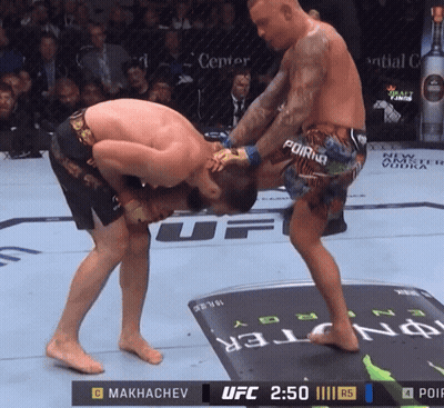 Two Men Fighting In UFC Ring With UFC 2:50 Displayed GIF