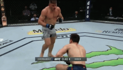 Two Men Fighting Monster In Boxing Ring GIF