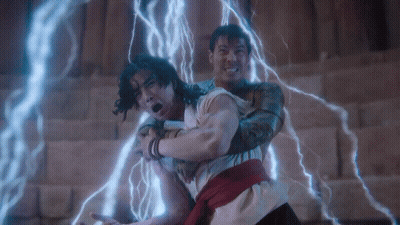 Two Men Fighting With Lightning Behind Them GIF