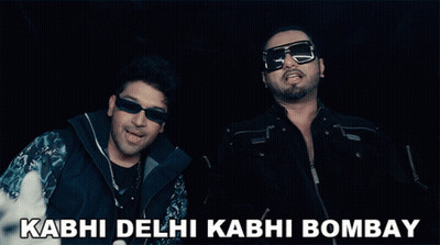 Two Men Giving A Thumbs Up With The Words Kabhi Delhi Kabhi Bombay In The Background GIF