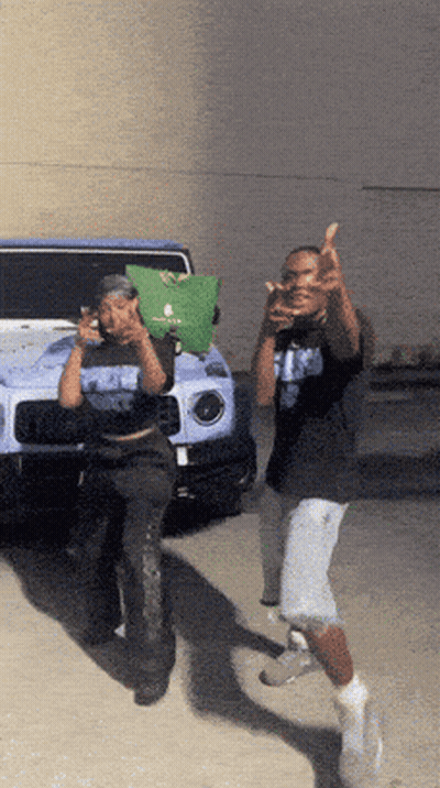 Two Men Giving Middle Finger In Front Of Blue Jeep GIF