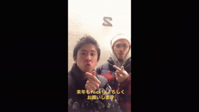 Two Men Giving The Middle Finger In Front Of A Sign That Says S GIF