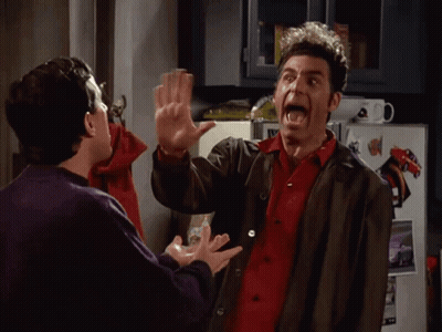 Two Men High Fiving In Front Of Refrigerator GIF