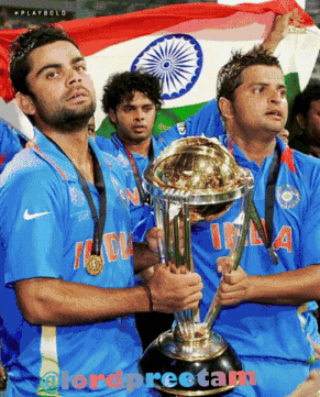 Two Men Holding A Trophy With The Word India On Their Jerseys GIF