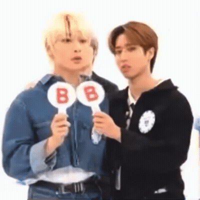 Two Men Holding B Signs GIF