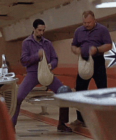 Two Men Holding Bags At Bowling Alley GIF