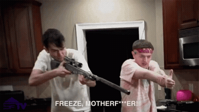 Two Men Holding Guns In Kitchen Saying Freeze Motherf**er GIF