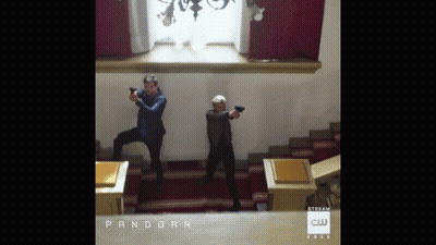 Two Men Holding Guns in Room Saying Pandora