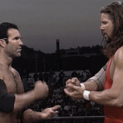 Two Men Holding Hands In Front Of Crowd GIF