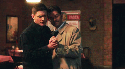 Two Men Holding Hands In Restaurant GIF