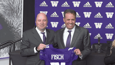 Two Men Holding Purple Jersey Saying Fisch GIF