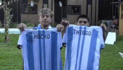 Two Men Holding Shirts With Nacho And Thiago GIF