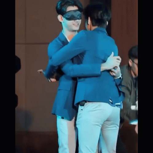 Two Men Hugging Blindfolded On Stage GIF