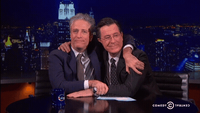Two Men Hugging In Front Of Comedy Central Logo GIF