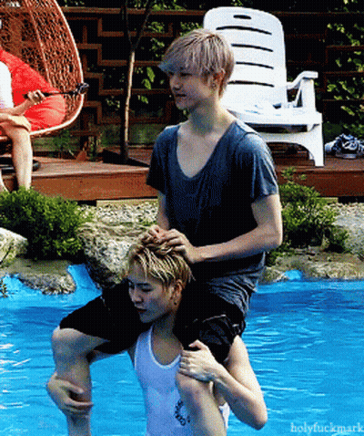 Two Men Hugging In Front Of Live Screen GIF