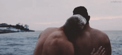 Two Men Hugging in Front of Ocean With Verberror