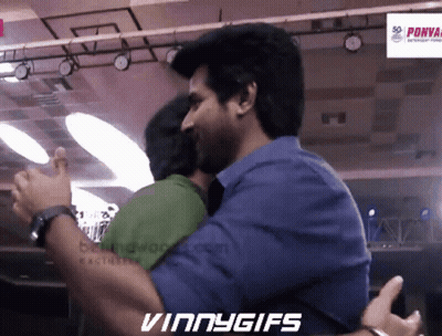 Two Men Hugging In Front Of Vinny Gifs Sign GIF