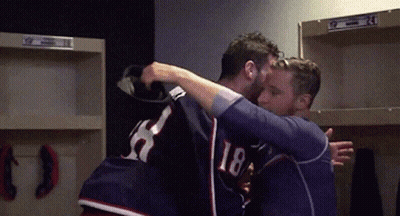 Two Men Hugging In Locker Room One Wearing 18 GIF