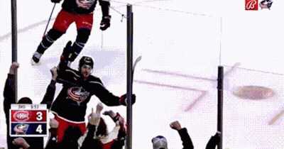 Two Men Hugging In Locker Room, One Wearing Jersey 18 GIF