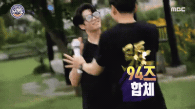 Two Men Hugging In Park, One In 94 Shirt GIF