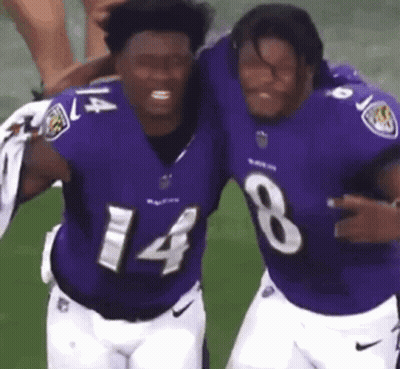 Two Men Hugging In Purple Jerseys GIF