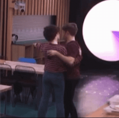 Two Men Hugging In Purple Light GIF