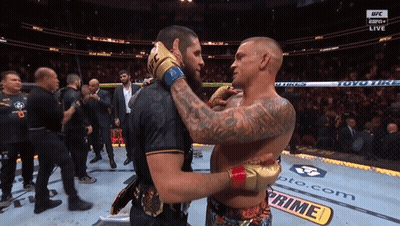 Two Men Hugging In UFC Ring GIF