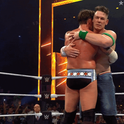 Two Men Hugging In Wrestling Ring With Letter W GIF