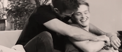 Two Men Hugging On Couch GIF