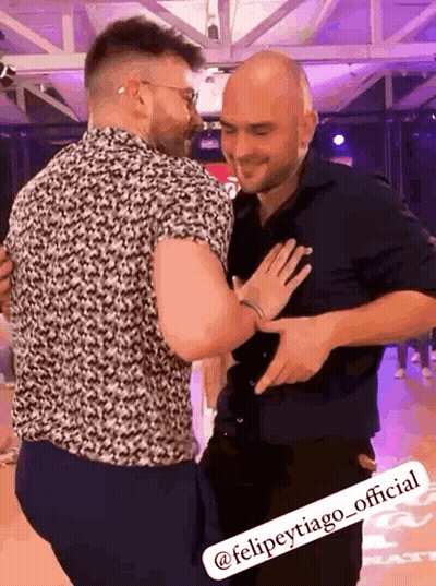 Two Men Hugging On Dance Floor One In Black Shirt GIF