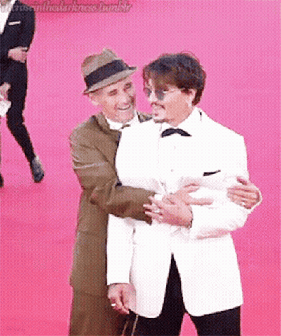 Two Men Hugging On Red Carpet GIF