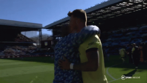 Two Men Hugging On Soccer Field GIF