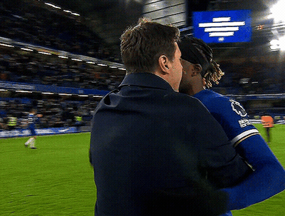 Two Men Hugging On Soccer Field With Everton Sign GIF