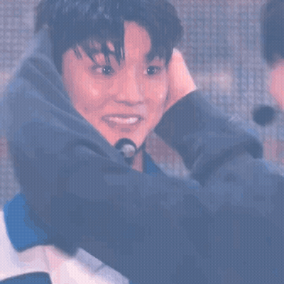 Two Men Hugging On Stage GIF