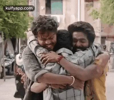 Two Men Hugging On Street GIF