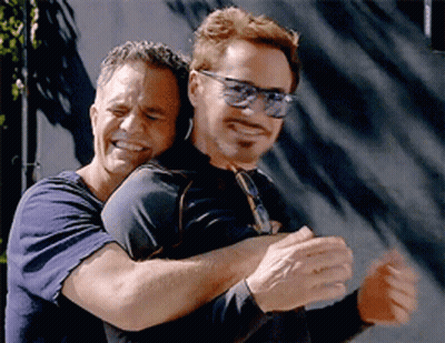 Two Men Hugging, One Wearing Sunglasses GIF