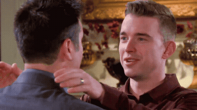 Two Men Hugging One With Ring GIF