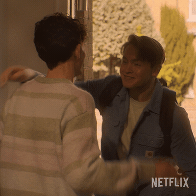 Two Men Hugging With A Netflix Logo Behind Them GIF
