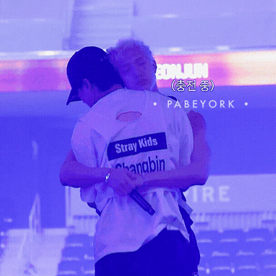 Two Men Hugging With One Wearing A Shirt That Says Stray Kids On It GIF