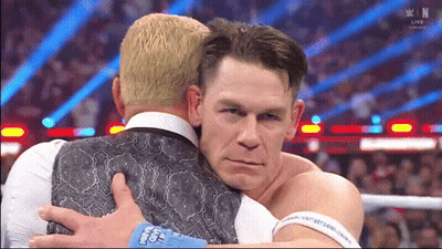 Two Men Hugging With One Wearing A Wristband That Says ' John Cena ' GIF