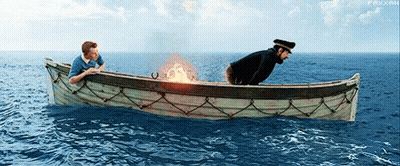 Two Men In A Boat In The Ocean With A Fire Coming Out Of The Side GIF
