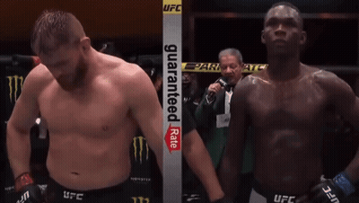 Two Men In A Boxing Ring With A Sign That Says Guaranteed Rate On It GIF