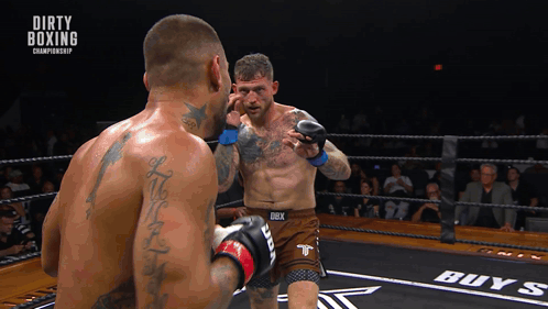 Two Men In A Boxing Ring With Dirty Boxing Championship Written On The Bottom GIF