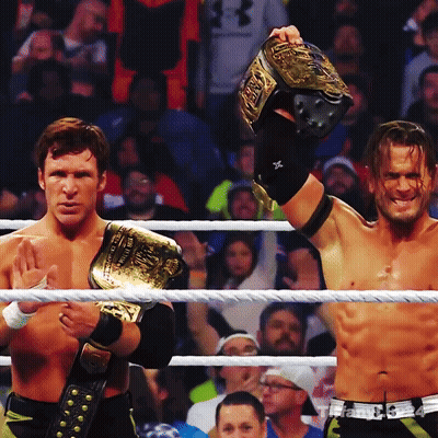 Two Men In A Wrestling Ring One Of Whom Is Wearing A Belt That Says ' Wwe ' On It GIF