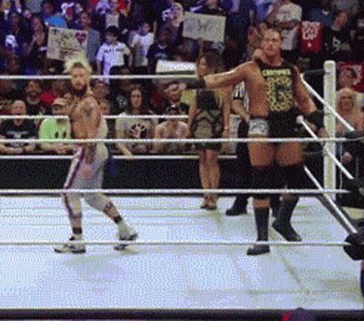 Two Men In A Wrestling Ring One Of Whom Is Wearing A Shirt That Says Choppers GIF