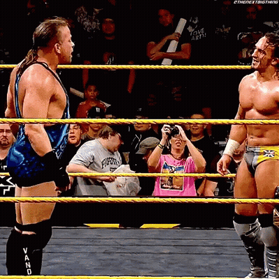 Two Men In A Wrestling Ring One Of Whom Is Wearing A Shirt That Says " I Love Earth " GIF